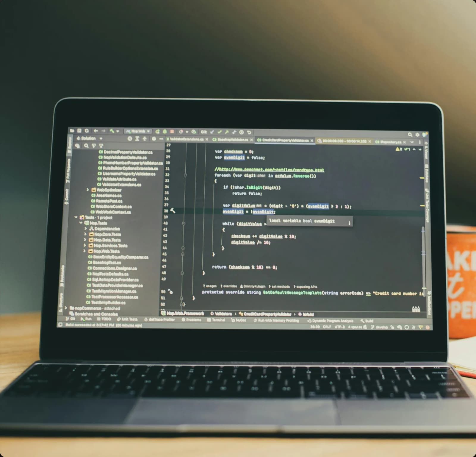 A laptop on a desk showing source code in a code editor